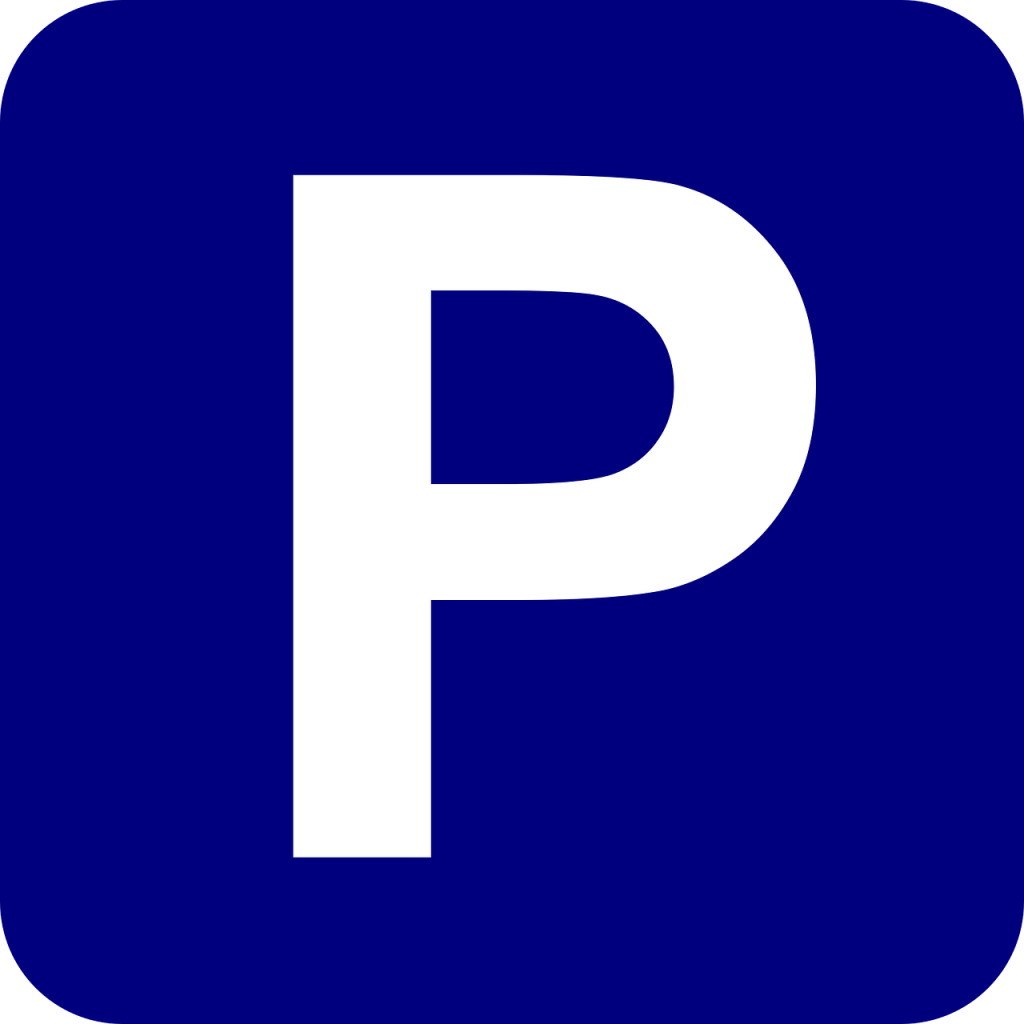 Símbolo de aparcamiento con fondo azul y letra "P" blanca, indicando la facilidad de acceso a clínicas dentales en Granada centro con estacionamiento gratuito.